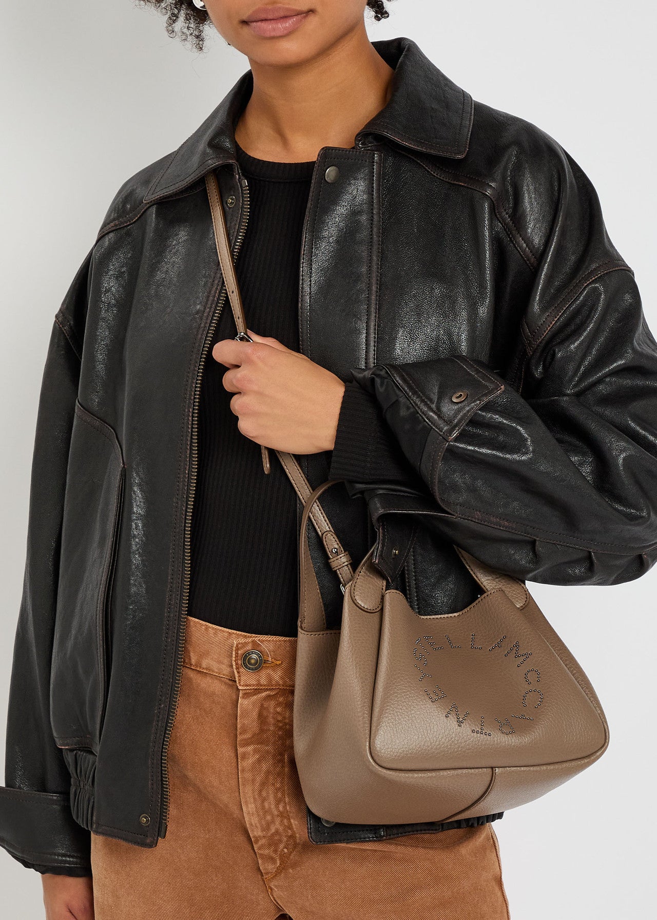 Logo studded faux leather top handle bag